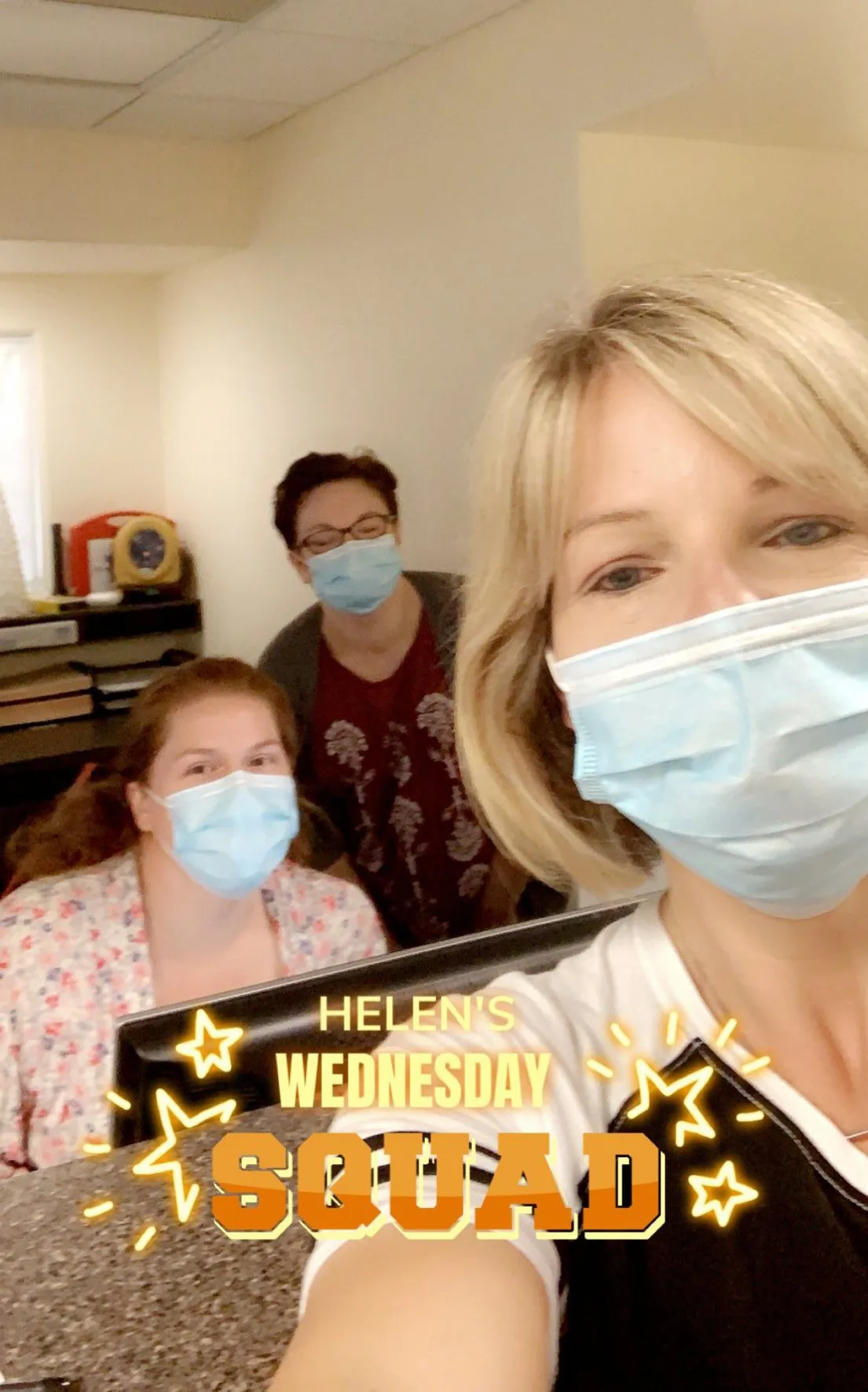Three staff members wearing masks